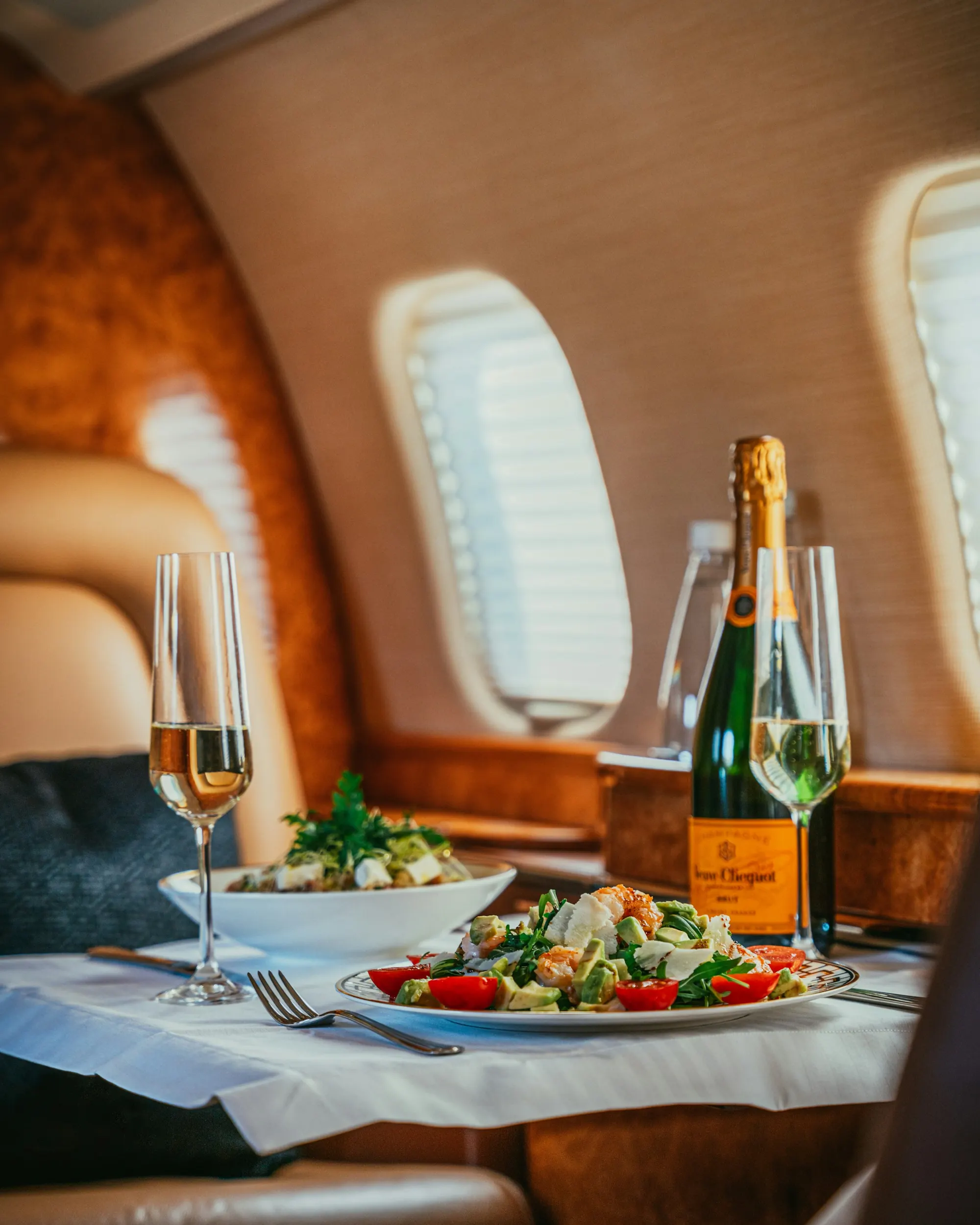 Champagne and a plated lunch served at a cabin window