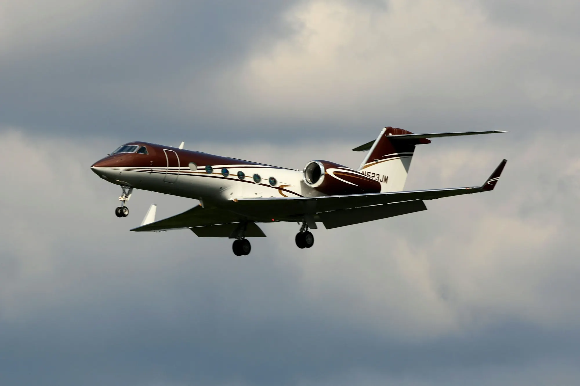 A business jet climbing against a grey sky